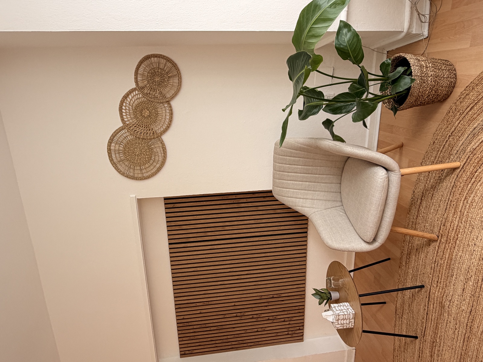 Gemütliche Sitzecke mit Sessel, Pflanze und Holz-Wandpaneel